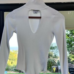 Very well kept! Long sleeve Bebe turtle neck bodysuit with peek-a-boo front